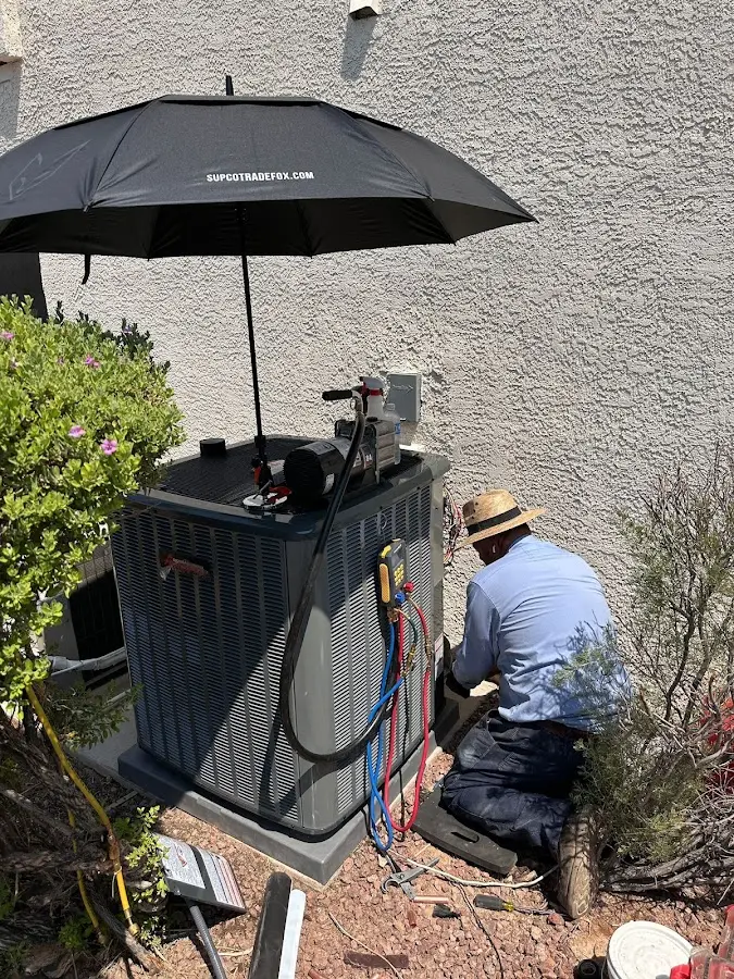 HVAC technician performing outdoor AC maintenance in Eunice